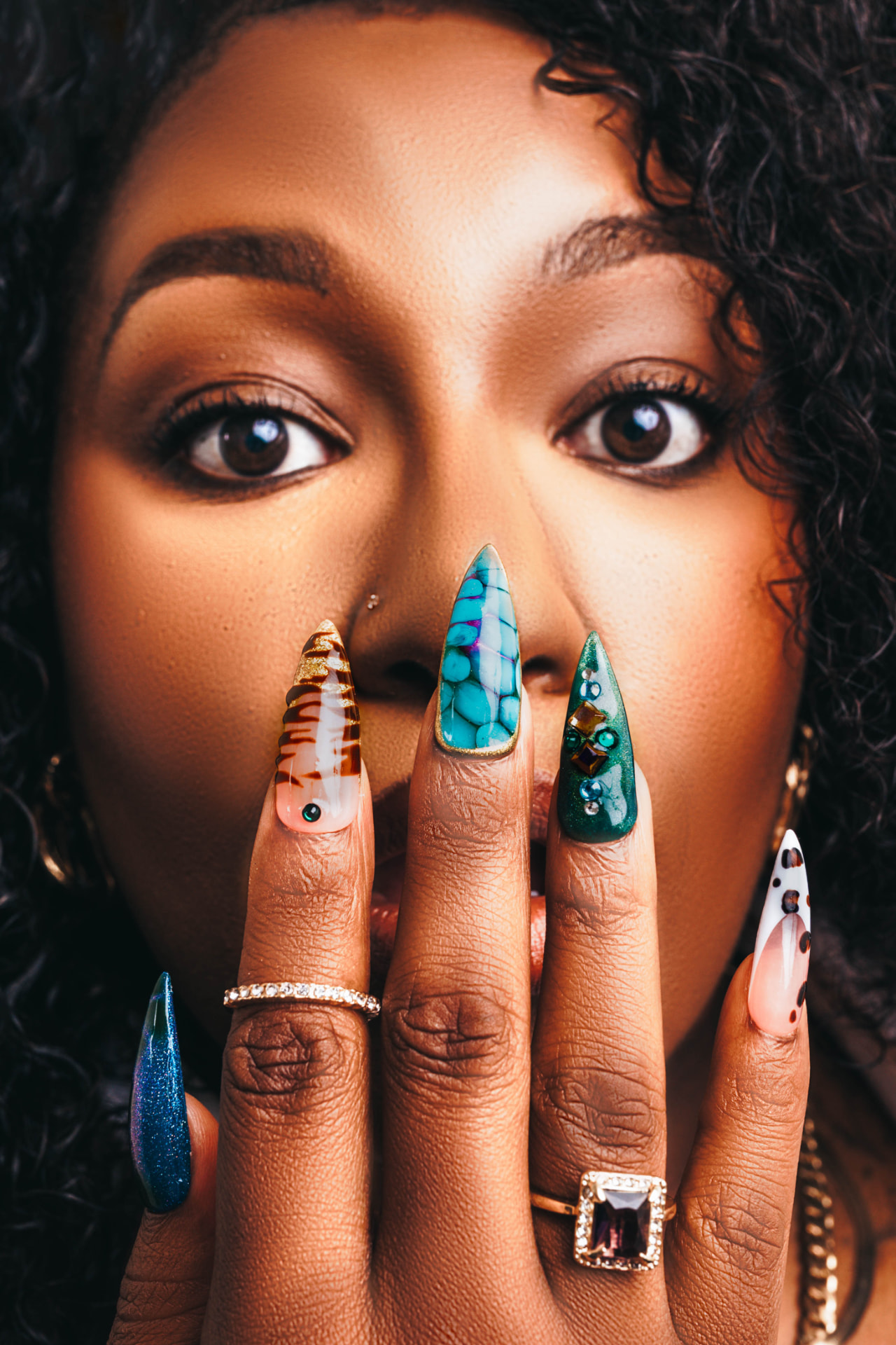 Woman wearing bold, hand-painted TIPZEE press-on nails